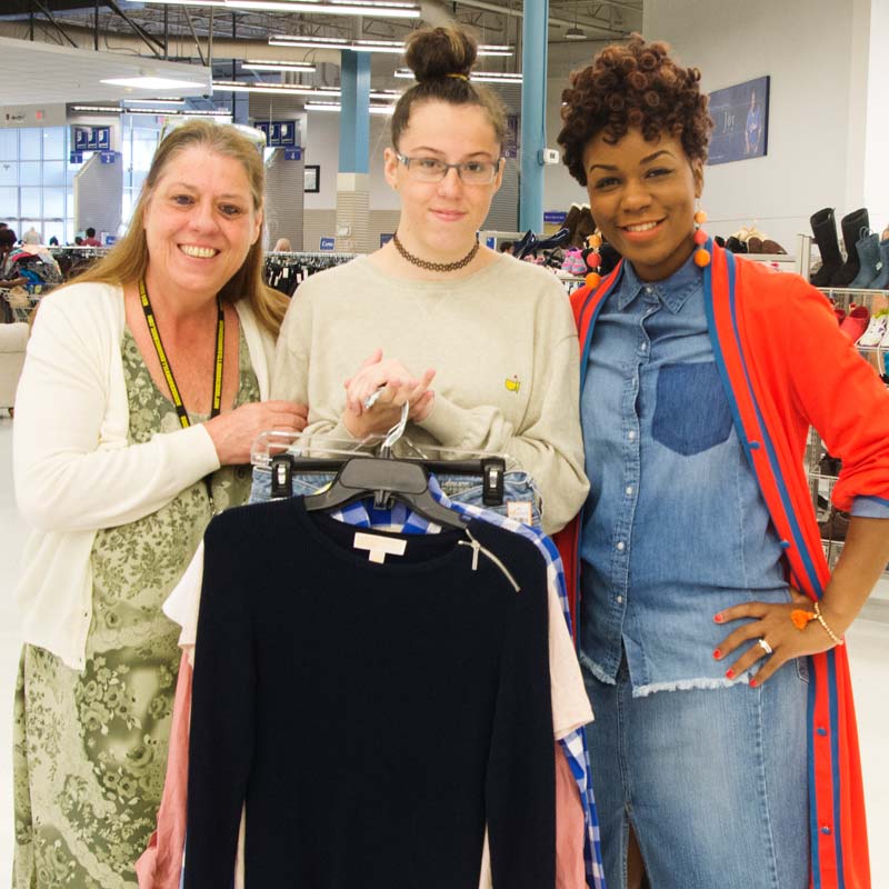 Melanie holds several of the outfits she received during her styling session with Porsche Pope, right. Melanie's Mom, Nancy, is also pictured.
