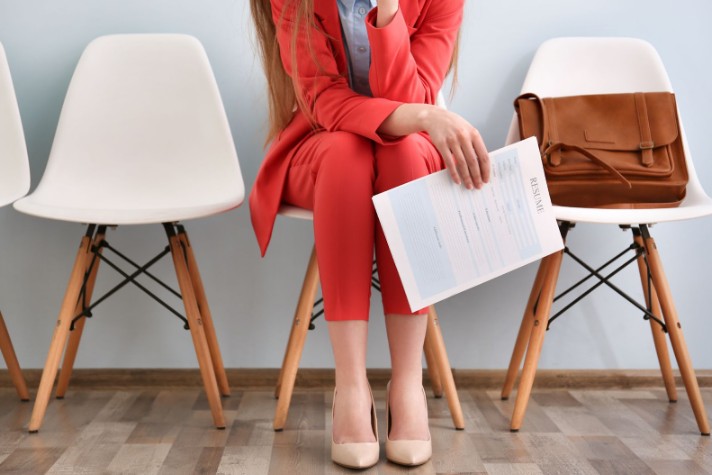 Young woman waiting for interview with essential documents and materials